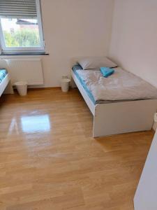 a bedroom with a bed and a wooden floor at L8 Street - Leipziger Straße in Kaiserslautern