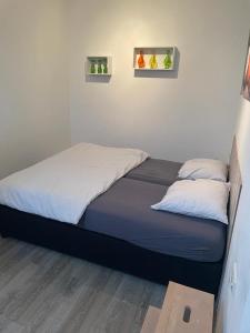a bed with two pillows on it in a bedroom at Appartement Pieterom in Sleen