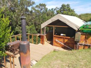 ein Pavillon mit einer Holzterrasse mit einem Zweijahreszeitraum in der Unterkunft Wilderness Glamping Tents in Wilderness