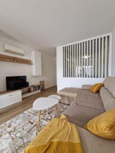 a living room with a couch and a table at RosaMar apartment sea view and pool in Albufeira