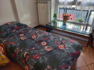 - un salon avec un lit et une table en verre dans l'établissement ROSY HOUSE, à Gênes