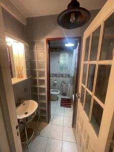 a small bathroom with a toilet and a sink at Casa Leloir in Villa Leloir