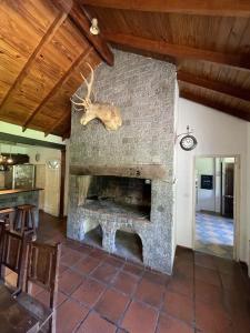 a living room with a stone fireplace in a house at Casa Leloir in Villa Leloir