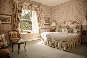 a bedroom with a bed and a window at Kinloch House Hotel in Blairgowrie