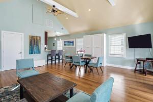 a living room with a table and chairs and a television at Sky Suite On Duval in Key West