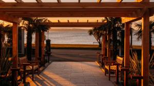 a pavilion with chairs and a view of the ocean at Brisbane House Hotel in Largs