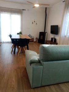 a living room with a couch and a table at La casita de la Alquería, Montanejos in Montanejos