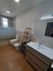 a bathroom with a sink and a toilet and a mirror at La casita de la Alquería, Montanejos in Montanejos