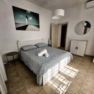 a bedroom with a bed with a picture of a lighthouse at MareSole Apartment in Lido di Ostia