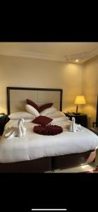 a bedroom with a large bed with towels on it at Over Mountains Hotel in Wadi Musa