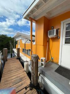 a dock with a house with a air conditioner on it at Updated houseboat on the river! in Fort Lauderdale
