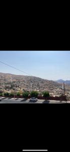 a view of a city with cars on a road at Over Mountains Hotel in Wadi Musa