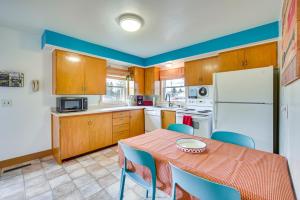 a kitchen with a table and chairs and a white refrigerator at Birchwood Cottage with Red Cedar Lake Access! in Birchwood +22 photos