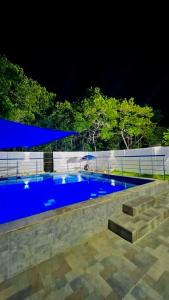 uma piscina com água azul à noite em Hotel Palmetto Beach Coveñas em Coveñas