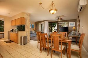 a kitchen and dining room with a table and chairs at Wailea Grand Champions Villas - CoralTree Residence Collection in Wailea