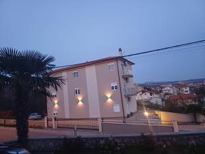 a white building with lights on the side of it at Bellamar Apartments Kastav - Opatija in Kastav