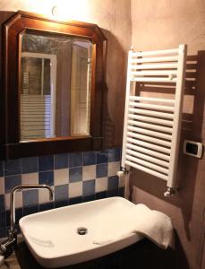 a bathroom with a sink and a mirror at San Martino Rooms & Breakfast in Borgio Verezzi