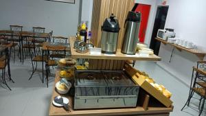 a kitchen with a stove in a room with tables at Let's Go Tour Palace Hotéis in Canaã dos Carajás