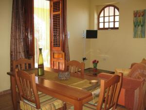 a dining room with a wooden table and chairs at Casa Dia in Trappeto