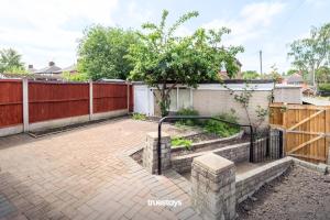 a patio with a fence and a tree at NEW Stanley House - Stunning 2 Bedroom House in Etruria