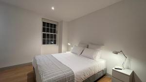 Uma cama ou camas num quarto em Matriz 55, Hostel & Suites
