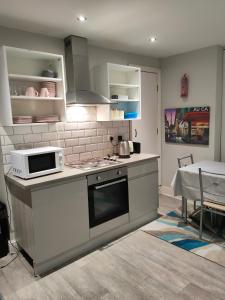a kitchen with a stove and a microwave at Beautiful Single Bedroom in Liverpool