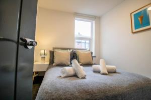 a bedroom with a bed with pillows on it at Cosy 1BR Retreat in Sunderland - Flat 3 in Sunderland