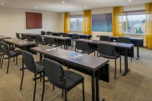 a conference room with tables and chairs and windows at SpringHill Suites Portland Airport in Portland