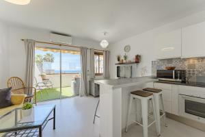 a kitchen and living room with a view of the ocean at 2bedroom LosGigantes Amazing View Free Parking Fibre in Acantilado de los Gigantes