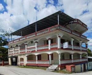 un gran edificio blanco con balcones en la parte superior. en Arnold's Guest House en San Ignacio