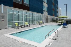 a swimming pool in front of a building at SpringHill Suites by Marriott Texas City in Texas City