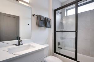 a white bathroom with a sink and a shower at Vizcaya #6 - Moab's Newest Luxury Rental in Moab