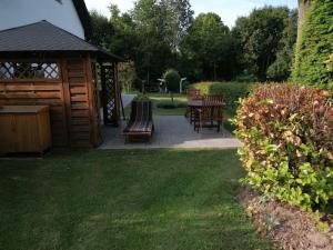 a gazebo with chairs and a table in a yard at Brini's Ferienwohnung im Grünen in Lage