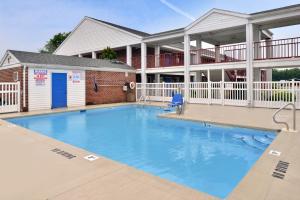 a large swimming pool in front of a building at Americas Best Value Inn Edenton in Edenton