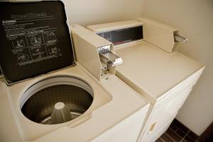 a washing machine with a box on top of it at Thunderbird Lodge in Mitchell