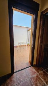 a door leading into a room with a table in a room at la casa del abuelo in Sebúlcor