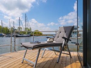 a chair sitting on the deck of a boat at Hausboot Krosse Krabbe - LP6 in Peenemünde