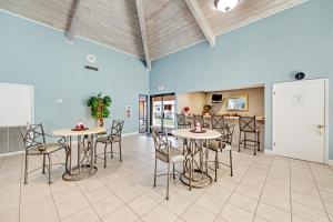 a room with two tables and chairs and a kitchen at Beach House in Destin