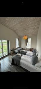 a large bedroom with two beds and a chandelier at Brimslóð Atelier Guesthouse in Blönduós