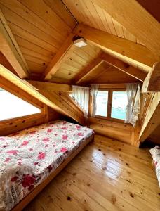 a bedroom in a log cabin with a bed in it at Splav Horizont in Gaočići