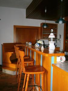 a kitchen with a wooden table and chairs at Hotel Strauss in Waldbronn