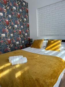 a bedroom with a bed with two towels on it at Apartamenty Dworcowe Stacja Centrum Kielce in Kielce