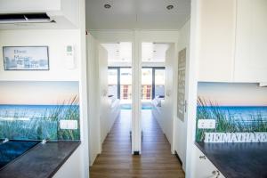 a hallway of a house with a view of the ocean at Hausboot Träumerei - LP3 in Peenemünde