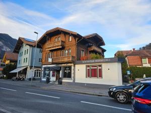 a wooden building on the side of a street at Loveroom in Interlaken