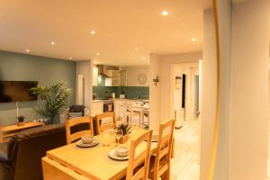 a dining room and kitchen with a table and chairs at The Great Escape Harrison Way in Cardiff