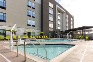 a swimming pool in front of a building at SpringHill Suites by Marriott Pleasanton in Pleasanton