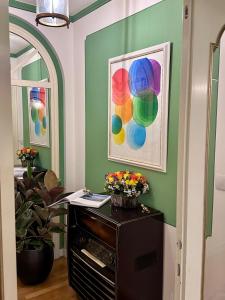 een kamer met groene muren en een tafel met bloemen bij Ponte Vecchio Escape Suite in Florence
