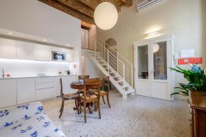 eine Küche und ein Esszimmer mit einem Tisch und Stühlen in der Unterkunft PAO Apartment - Veronetta 1 in Verona
