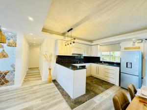 a kitchen with white cabinets and a blue refrigerator at Vans Haven in Curepipe +11 photos