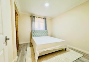 a small bedroom with a bed and a window at Vans Haven in Curepipe